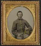 [Unidentified young soldier in Confederate uniform holding book]