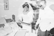 Josephine Bradford and Walter Bradley looking at gifts spread out on a bed during their wedding reception in in Montgomery, Alabama.