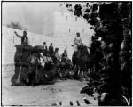 Camel tenders pose outside the walls of the Jerusalem concession at the 1904 World's Fair