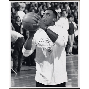 Former NFL player Irving Fryar shooting a basketball at a fund-raising event held by the Boys and Girls Clubs of Boston and Boston Celtics