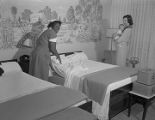 Rosie Lee Cleveland changing the sheets on a bed at Doby's Hotel Court at 3453 Mobile Road in Montgomery, Alabama.