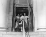 Autherine Lucy, Arthur Shores, and Thurgood Marshall leaving the federal courthouse in Birmingham, Alabama, after a hearing.