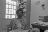 John Blassingame: New York. John Blassingame seated in office, Fredrick Douglas portrait on the wall (BLJP 1-79 #101)