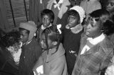 Children in the group "Buds of Promise" from Mt. Zion AME Zion Church in Montgomery, Alabama, singing to an elderly woman in her home.