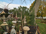 Stewart Melrose, an interior designer and historical preservationist in Fenton, Michigan, picked up a love of ornamental gardening from his father and mother, Howard and Sonya Melrose. Together, they created and regularly expand a remarkable garden beside the parent's home. It includes tropical flowers collected around the world, stacked stone piles called "cairns" (shown), and larger rock sculptures, one of which occasionally erupts with smoke like a volcano. The Melroses consider their creation a community garden, open to all