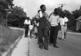 Edward Rudolph leading marchers down a street in Prattville, Alabama, during a demonstration sponsored by the Autauga County Improvement Association.