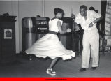 Couple dancing in front of jukebox