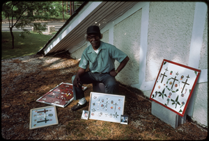 Thumbnail for Outsider art: Theodore Hill. Theodore Hill with some of his visual art pieces