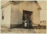 [Pioneer School #13 (6 miles northwest of Shawnee) opened October 2nd 7 months term. Miss Lela Ginsinger, Principal (been here 2 years). Photo shows only 6 children present and 2 teachers in the third week of school. Expect 24 pupils. All absences are due to cotton. A few of the larger ones will be out in the Spring for cotton. Lewis W. Hine. See W. H. Swift Report.]  Location: [Potawotamie County, Oklahoma]