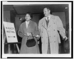 [Thurgood Marshall walking with an unidentified woman by sign reading "N.A.A.C.P. meeting"]