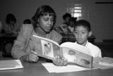 A Marquette student reads with a young boy, 1995