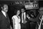 Muhammad Ali standing with others at a rally for Tom Bradley, Los Angeles, 1983