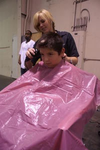 [Barber Cuts Hair of a Young Man}