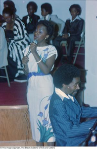 Photograph of young woman singing at the Black Women in Arts conference