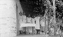 Girls cooking and serving lunch to teachers. Meeting of Beaverdam Home Makers Club in house (log cabin) of member