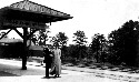 An unidentified couple standing at a railroad station