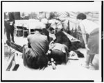 Followers of Malcolm X try to comfort fiery renegade of the negro radical movement, as he lies mortally wounded on stage in an upper Manhattan ballroom Feb. 21, after he was cut down by bullets