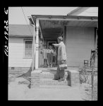 Newport News, Virginia. Negro shipyard worker leaving his rural home for the shipyards with his lunch box