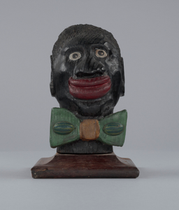 Bust in the form of a caricatured man wearing a watermelon bow tie