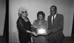 Mickey Champion posing with an award at the Pied Piper nightclub, Los Angeles, 1984