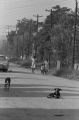 Women and children walking down a dirt road in Newtown, a neighborhood in Montgomery, Alabama.