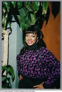 Photograph of BernNadette Stanis with her hands on her hips