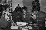 Southern Courier staff members judging contest entries in a house or apartment in Montgomery, Alabama.