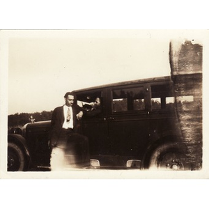 Reverend Dr. Wm. Frederick Fisher leans against a car