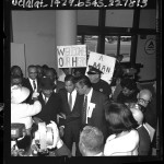 Dr. Martin Luther King being greeted by crowd upon his arrival at Los Angeles airport, 1965