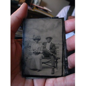 An African American couple sitting on a bench