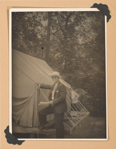 Photograph of a man by a tent at J.K. Orr camp, Lovejoy, Georgia