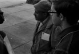 Scott B. Smith of SNCC speaking with Mike Bibler and John Davis of SCLC, in front of the Barbour County courthouse in Eufaula, Alabama.