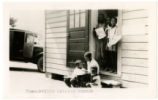 African-American children hold books in doorway of "Thomasville Colored Branch" library