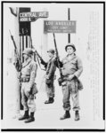 Thumbnail for Three National Guardsmen stand guard under a Los Angeles city limits sign in the southern end of the riot torn section of the city