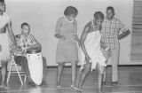 Viola Bradford learning a traditional African dance in a gymnasium, probably in Montgomery, Alabama..