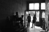 James "Son" Thomas and Joe Cooper in Leland, Mississippi. Bar, shoeshine parlor, promotional posters. (JTP 5-76-3)