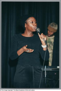 Photograph of a woman puffing her lips to a microphone