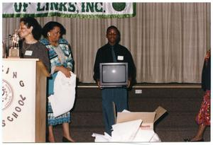 Speakers and Boy with Television at Salute to Youth Awards Program