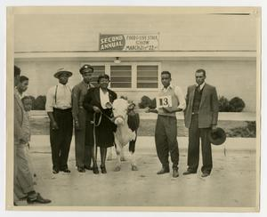 People and a Cow at the Food and Livestock Show