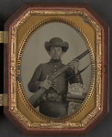 [Unidentified soldier in Confederate uniform with musket, knife, and sign reading Victory or Death! atop two books]