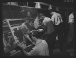 Production. B-25 "Billy Mitchell" bombers. Negro and white work together at North American's Inglewood, California, plant, turning out planes to defeat the Axis. Here, employees of both races assemble the wing panels for a B-25 bomber. In addition to the battle-tested B-25 "Billy Mitchell bomber, used in General Doolittle's raid on Tokyo, this plant produces the P-51 "Mustang" fighter plane which was first brought into prominence by the British raid on Dieppe