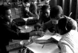 Young woman helping seventh-grade students with school work in the basement of St. Paul's Lutheran Church in Birmingham, Alabama.