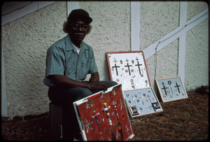 Outsider art: Theodore Hill. Theodore Hill with some of his visual art pieces