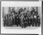 [Group portrait of over sixty men and women, primarily African American men, posed in front of a brick building, probably in Washington, D.C.; Nannie Helen Burroughs appears in front row]