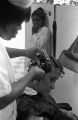 Woman having her hair put up in curlers at a beauty salon in Montgomery, Alabama.