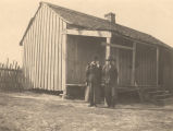 African American man and woman standing in front of a cabin in Crawford, Alabama.