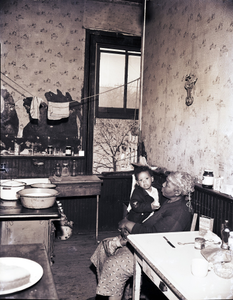 Kitchen with woman holding child : photonegative.