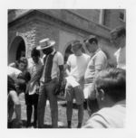 Mississippi State Sovereignty Commission photograph of Victoria Gray [sic] standing with a group of men and women and looking at items on the ground during a training session for COFO volunteers in Oxford, Ohio, 1964