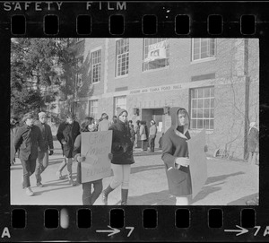 White students parade with placards outside Ford Hall at Brandeis University