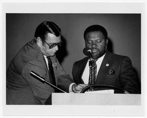 Two Men in Suits at Podium